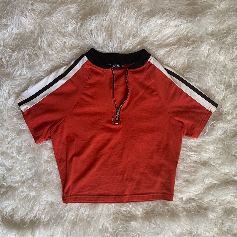 Orange striped crop top with silver zipper front.
